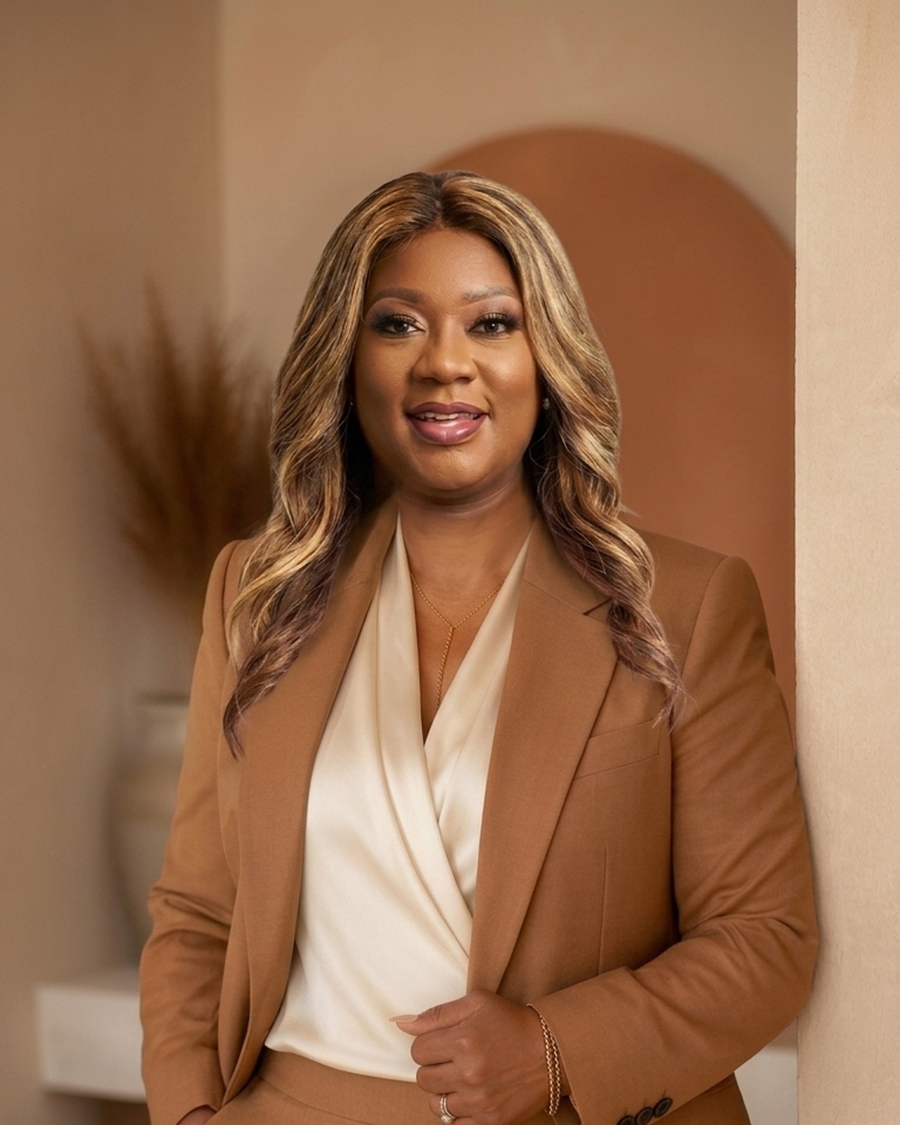 Linda Boyce, AI consultant for beauty and wellness professionals, in a camel blazer